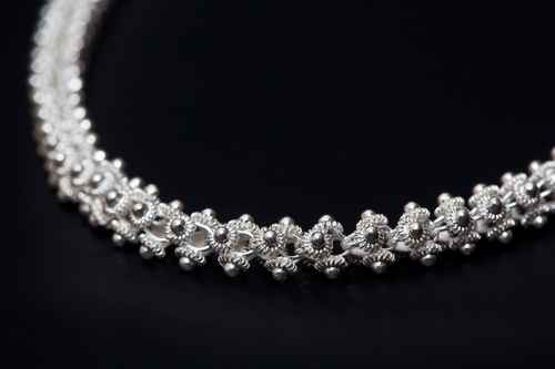 Sterling silver necklace close-up over dark background